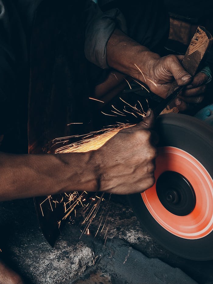 services-04 Detailed close-up of a craftsman using a grinding wheel, creating sparks.
